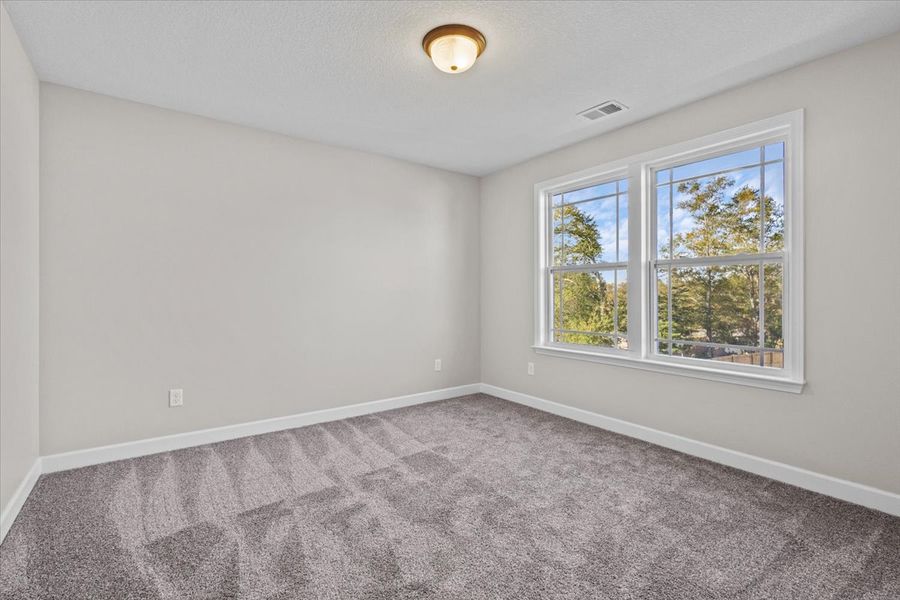 Representative unfurnished interior of a home built from the Iris by Enchanted Homes in Hampshire Heights, Moore (Image 10).