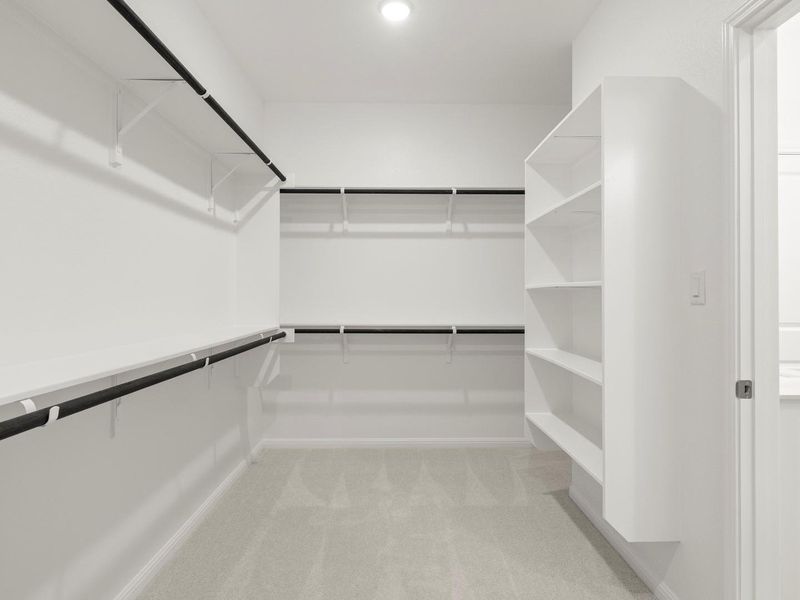Ample shelving and hanging space in this well-appointed walk-in closet.