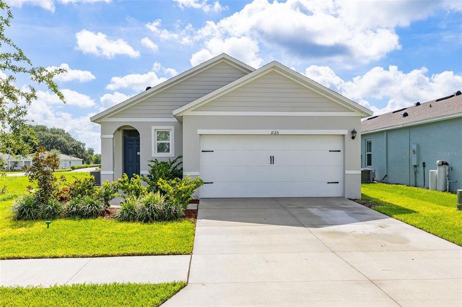 Front exterior of a new home in Bradbury Creek, Haines City, FL, highlighting curb appeal (Image 21). Front exterior of a new home in Bradbury Creek, Haines City, FL, highlighting curb appeal (Image 21).