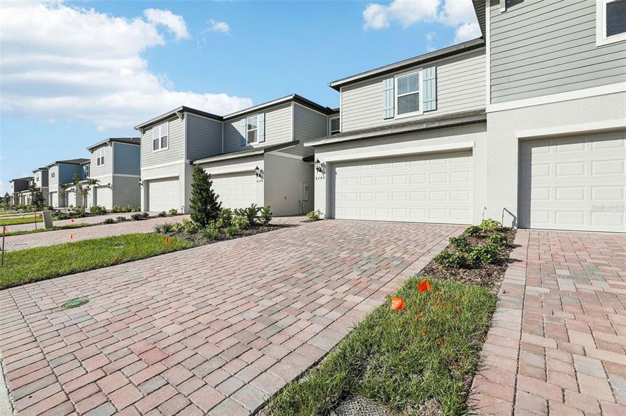 Exterior details and patio area of a home in The Meadow at Crossprairie Bungalows, St. Cloud (Image 3).