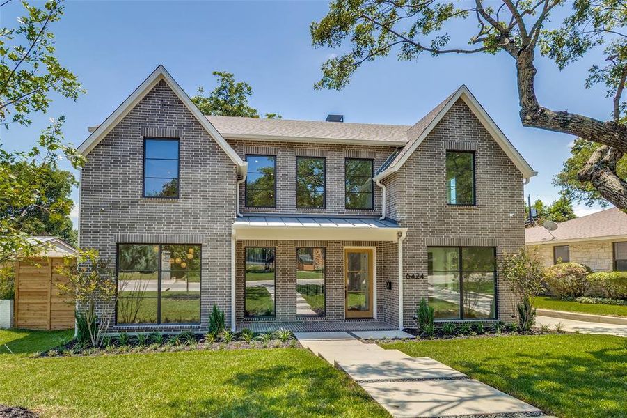 View of front of property with a front lawn, brick siding, and covered porch View of front of property with a front lawn, brick siding, and covered porch