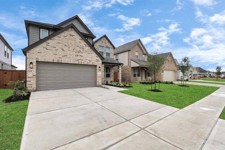 Home showcases a convenient 2-car garage paired with a spacious driveway, providing ample room for parking.