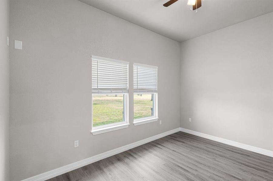 Unfurnished room featuring ceiling fan and wood finished floors
