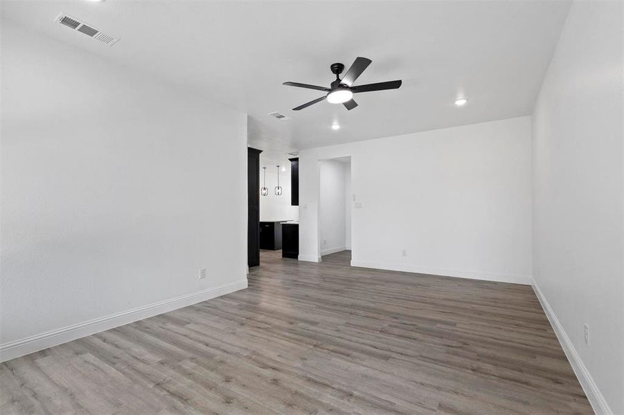 Empty room featuring hardwood / wood-style floors and ceiling fan