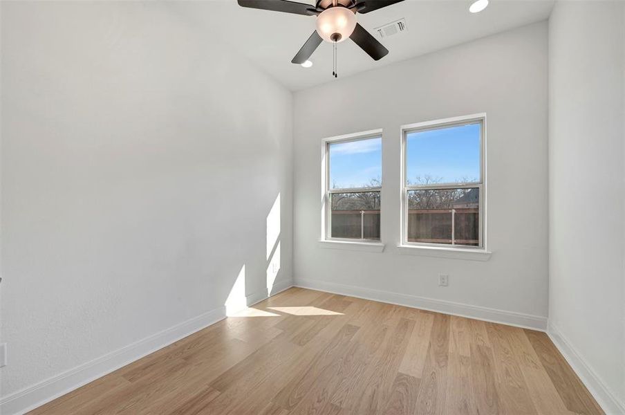 Spare room featuring light wood finished floors, ceiling fan, and recessed lighting Spare room featuring light wood finished floors, ceiling fan, and recessed lighting