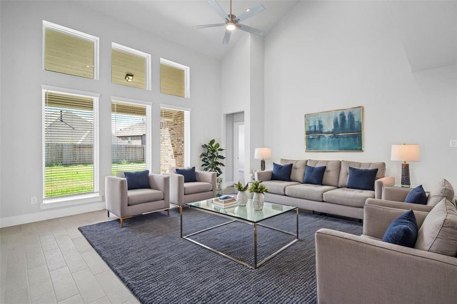 Gather the family and guests together in your lovely living room! Featuring high ceilings, recessed lighting, ceiling fan, custom paint, gorgeous floors and large windows that provide plenty of natural lighting throughout the day.