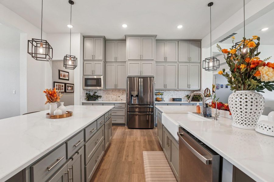 Elegant pendant lighting and modern fixtures complement the timeless finishes throughout.