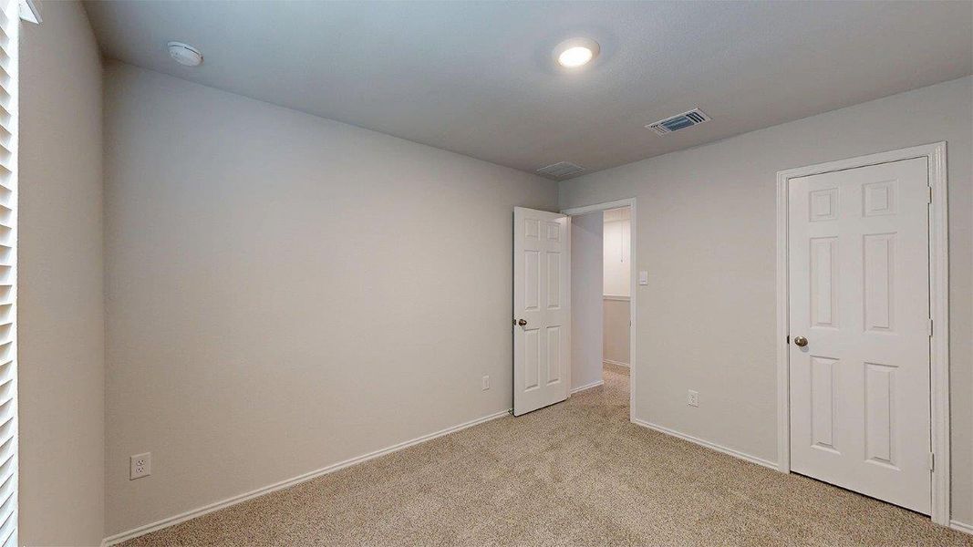 Unfurnished bedroom with carpet floors and baseboards Unfurnished bedroom with carpet floors and baseboards