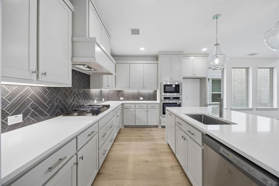 Beautiful cabinetry, gorgeous counter tops and designer backsplash effortlessly pair with contemporary stainless steel to create a dream kitchen for the ages!