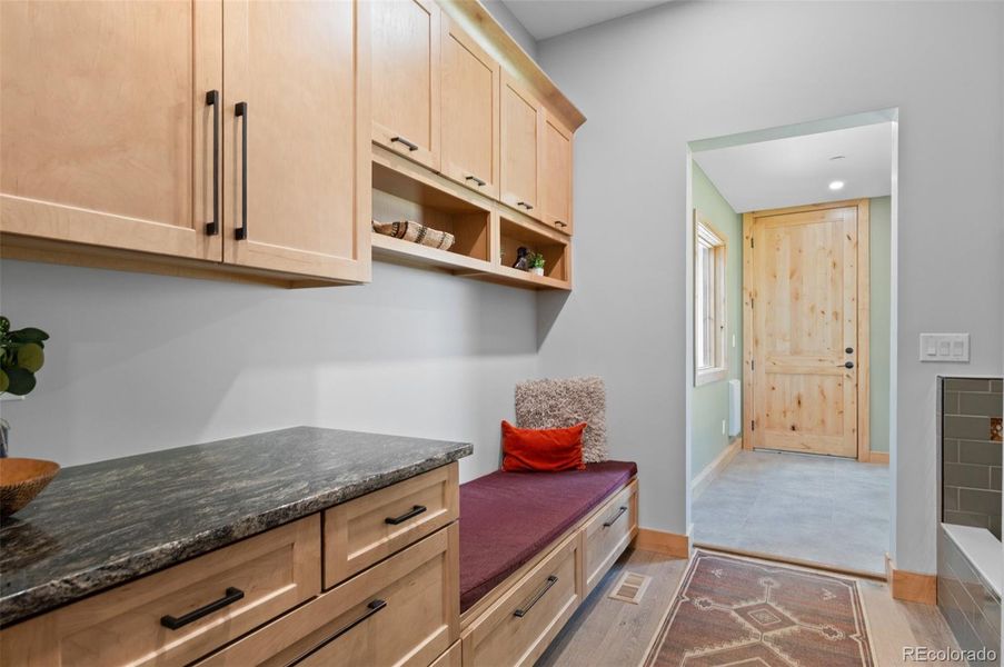 Mud Room with plenty of cabinets, bench, and a Dog Bath!