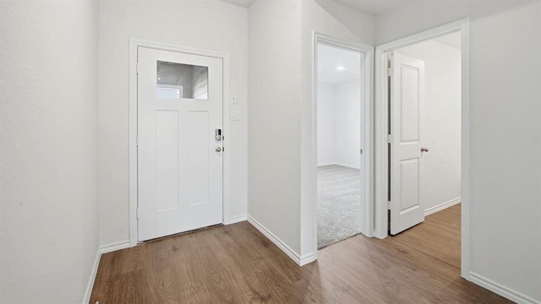 Entrance foyer featuring wood finished floors