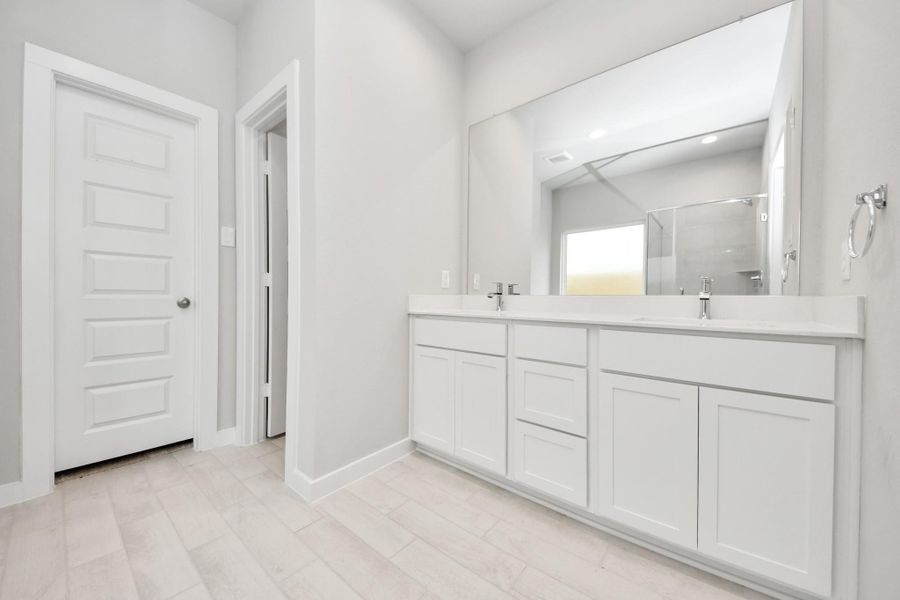 Elevate your daily routine at the elegant vanity, now equipped with double sinks, light countertops, modern hardware, and beautiful recessed lights. Sample photo of completed home with similar floor plan. Actual colors and selections may vary. Elevate your daily routine at the elegant vanity, now equipped with double sinks, light countertops, modern hardware, and beautiful recessed lights. Sample photo of completed home with similar floor plan. Actual colors and selections may vary.