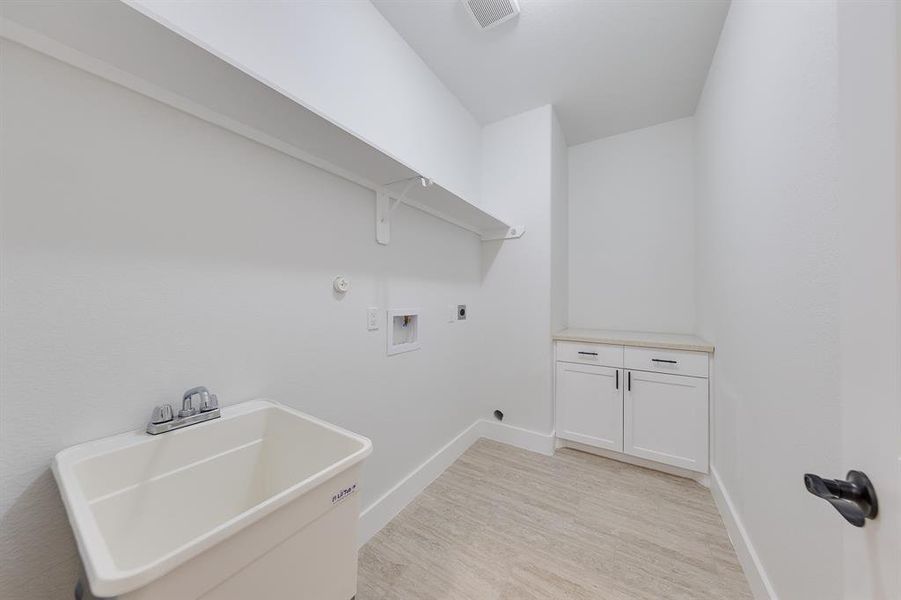 Conveniently located utility room inside the house, offering easy access for laundry and additional storage space.