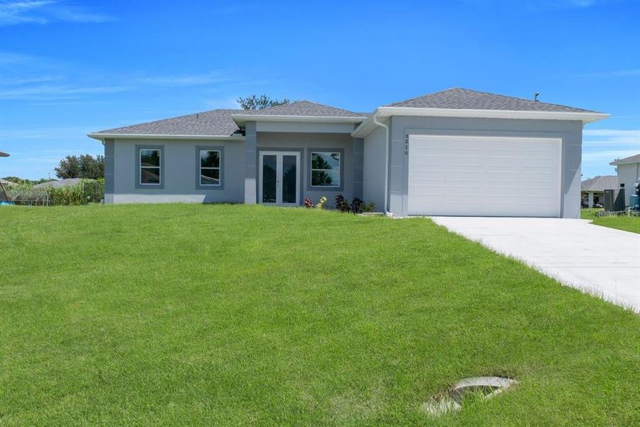 Front exterior of a new home in , Lehigh Acres, FL, highlighting curb appeal (Image 1). Front exterior of a new home in , Lehigh Acres, FL, highlighting curb appeal (Image 1).