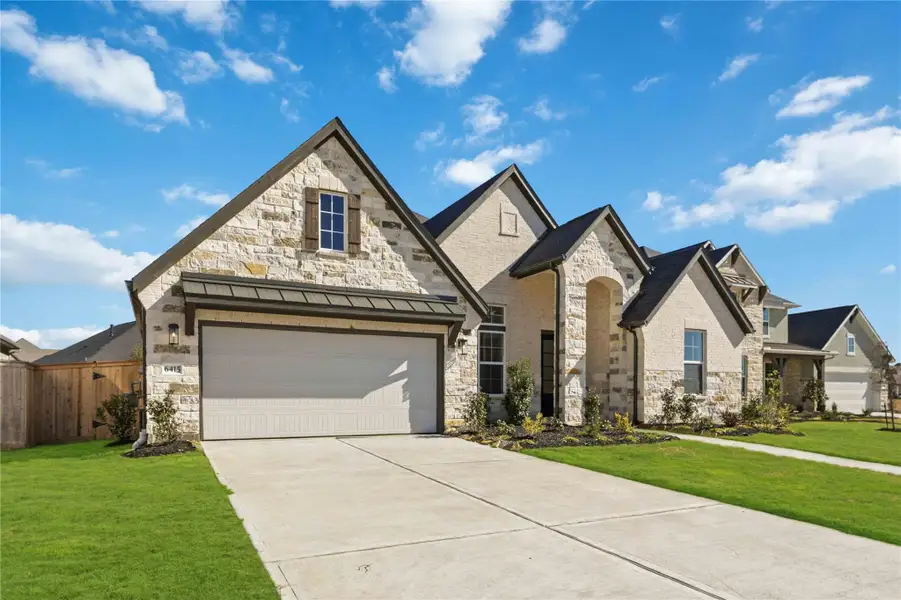 Front exterior of a new home in Valencia, Manvel, TX, highlighting curb appeal (Image 2).