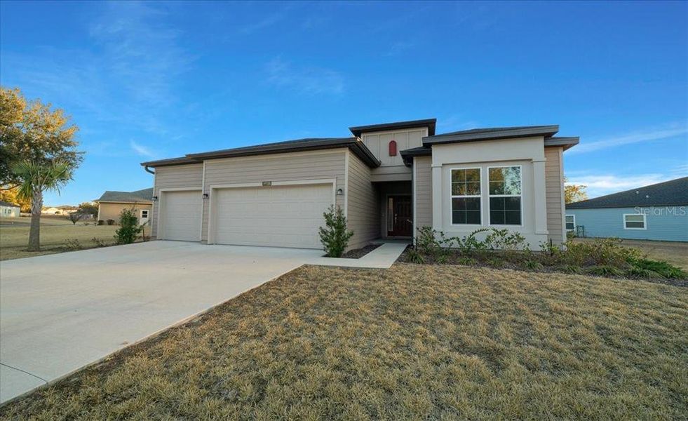 Front exterior of a new home in Grand Park North, Dunnellon, FL, highlighting curb appeal (Image 30).