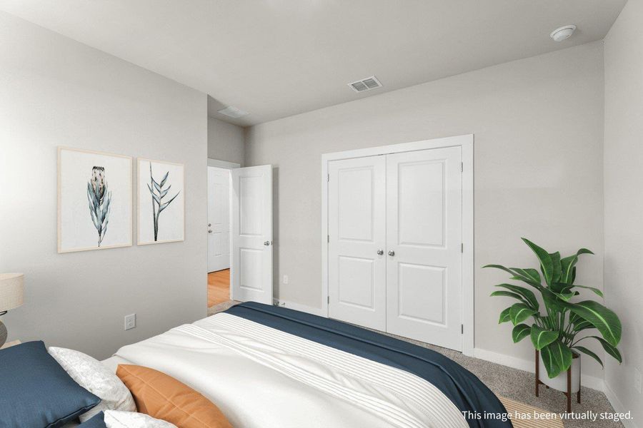 Comfortable bedroom with plush carpeting and crisp white doors offers a peaceful retreat. Comfortable bedroom with plush carpeting and crisp white doors offers a peaceful retreat.