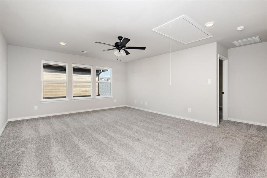 Spare room with light carpet, attic access, recessed lighting, and a ceiling fan