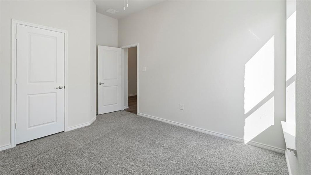 Unfurnished bedroom with carpet floors and baseboards Unfurnished bedroom with carpet floors and baseboards