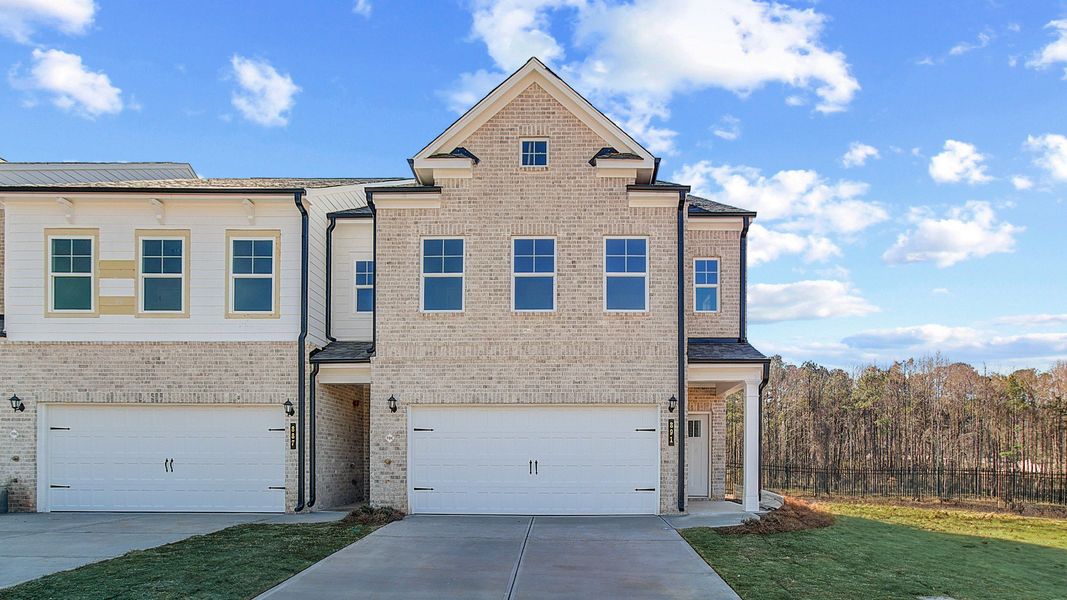 Modern kitchen in new construction townhome in Riverdale, GA with large island, quartz countertops, and stainless appliances.