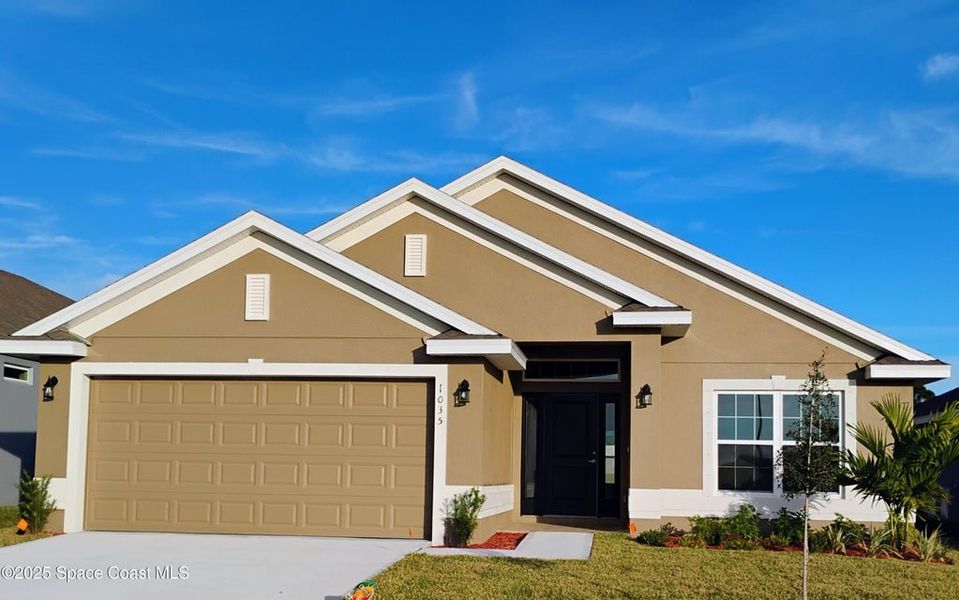 Front exterior of a new home in St. John Preserve, Palm Bay, FL, highlighting curb appeal (Image 1). Front exterior of a new home in St. John Preserve, Palm Bay, FL, highlighting curb appeal (Image 1).