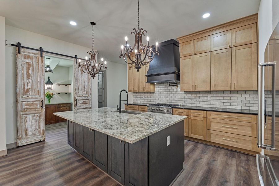 The warm two-toned cabinetry and beautiful quartz countertops add timeless style and sophistication