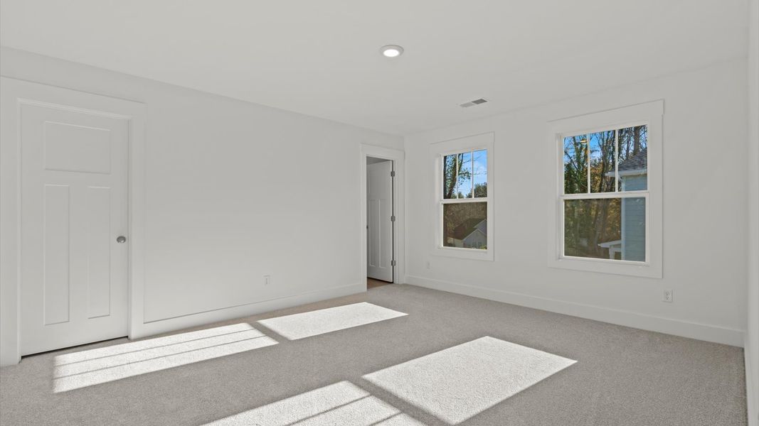 Vibrant and restful bedroom with oversized windows, refined detail, and a warm, welcoming atmosphere