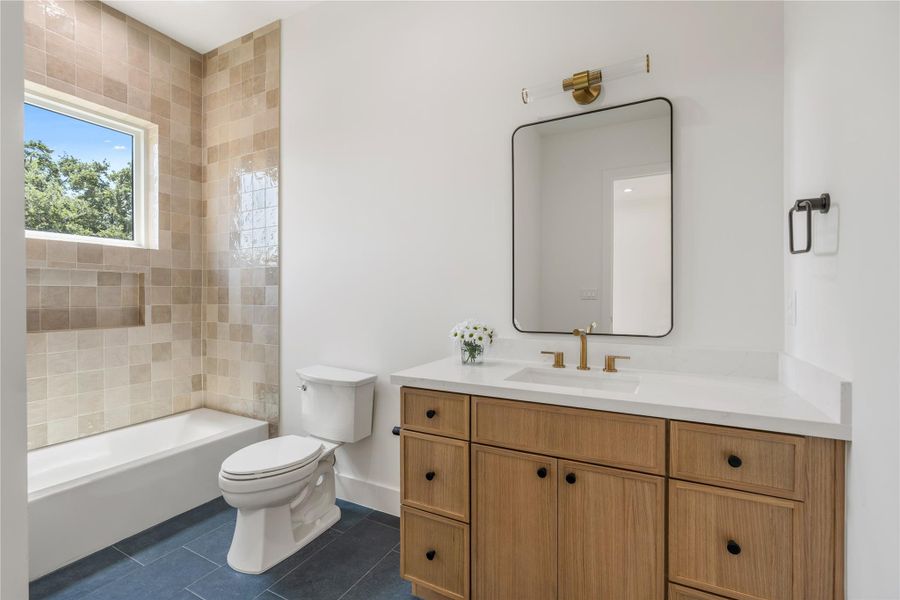 Secondary bath featuring spacious vanity and quality finishes.