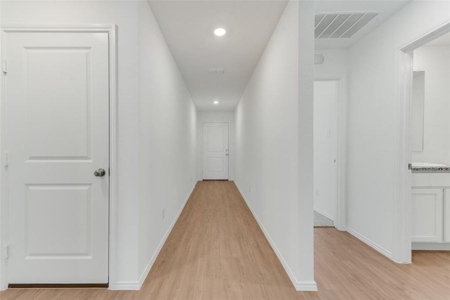 Hall with light hardwood / wood-style floors