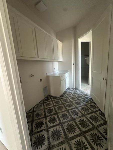 Utility room conveniently connects to primary closet