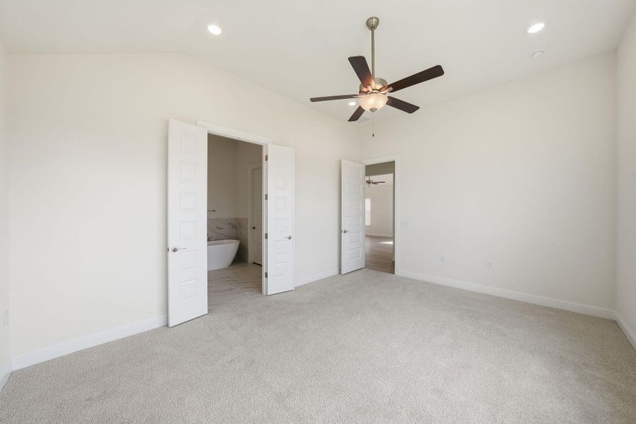 Unfurnished bedroom featuring light colored carpet, ensuite bathroom, recessed lighting, and a ceiling fan Unfurnished bedroom featuring light colored carpet, ensuite bathroom, recessed lighting, and a ceiling fan