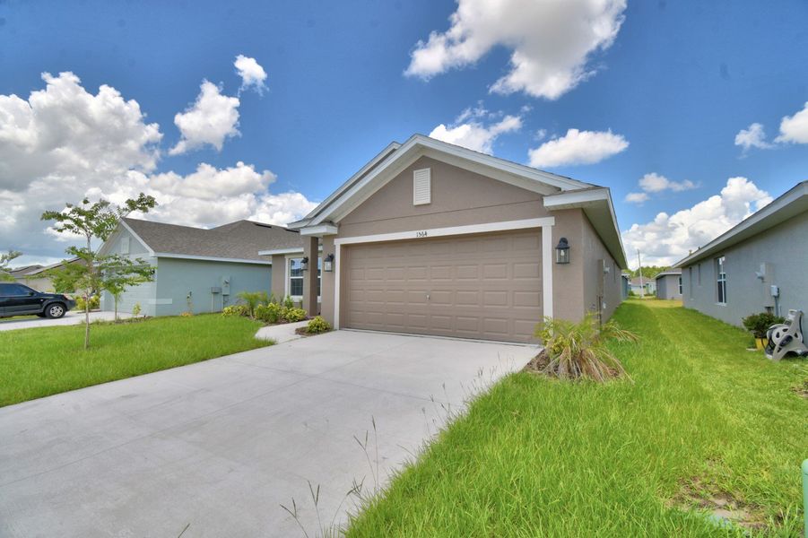 Front exterior of a new home in Villamar, Winter Haven, FL, highlighting curb appeal (Image 18).