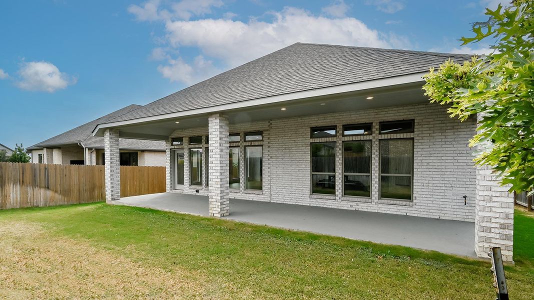 Back of house featuring brick siding, a patio area, and roof with shingles Back of house featuring brick siding, a patio area, and roof with shingles
