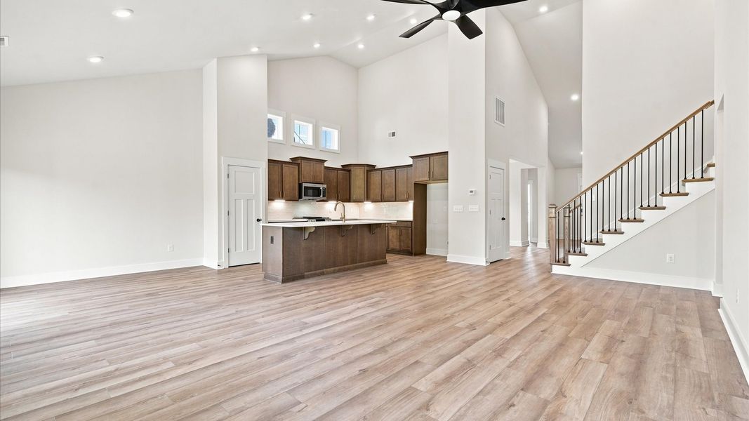 Accomplished design shines in this vibrant family room with dramatic two-story ceilings and open-concept flow