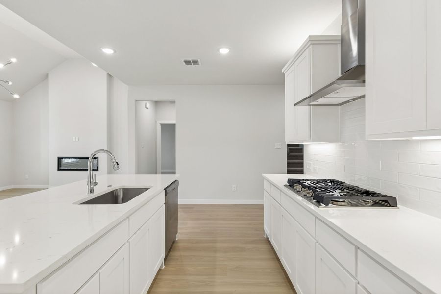 Kitchen in the Masters home plan by Trophy Signature Homes – REPRESENTATIVE PHOTO