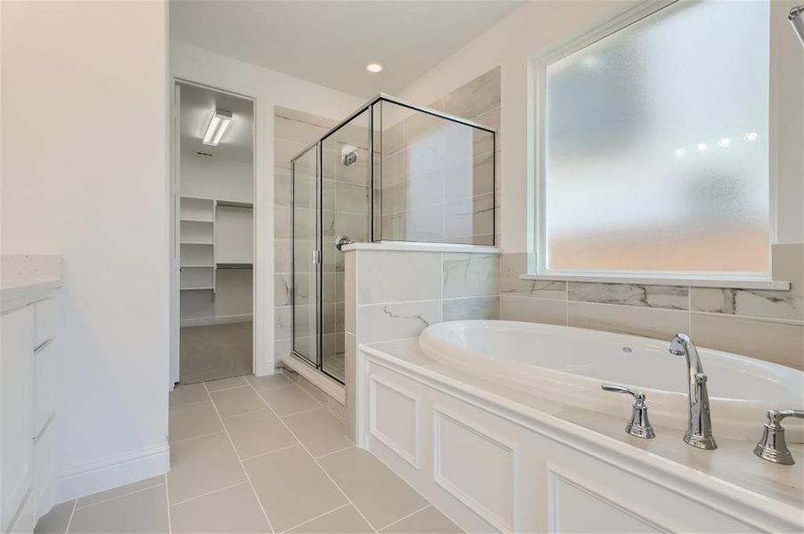 Bathroom with tile floors and independent shower and bath