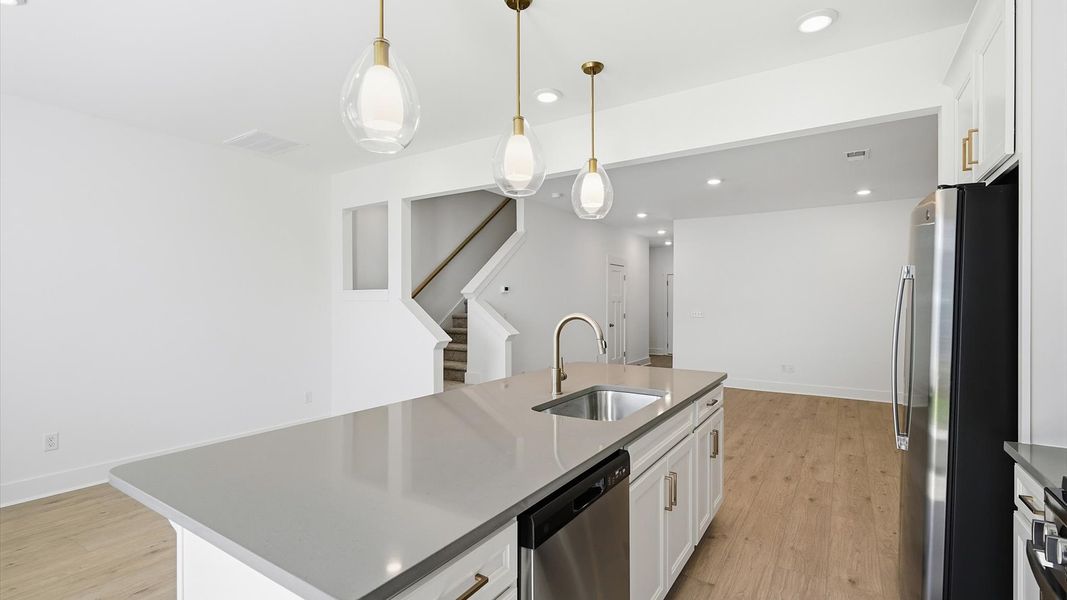 Accomplished design in a kitchen that blends function and form with a right-sized island at the Barton Hollow community Accomplished design in a kitchen that blends function and form with a right-sized island at the Barton Hollow community