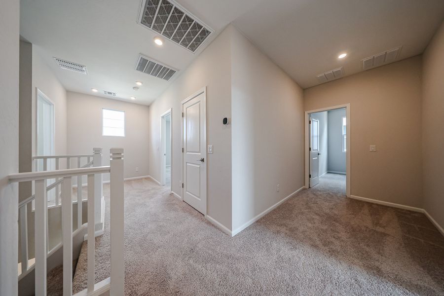 A hallway with white doors.