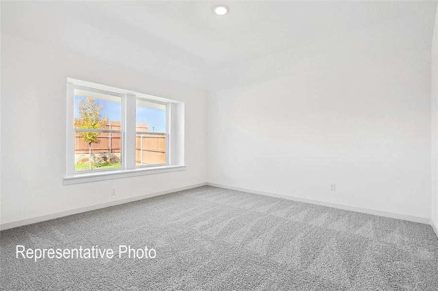 Spacious room featuring neutral carpeting, white walls, a recessed ceiling light, and a double window with a white frame