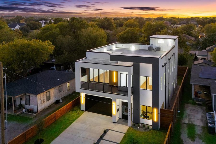 View of fully lighted home at dusk. View of fully lighted home at dusk.