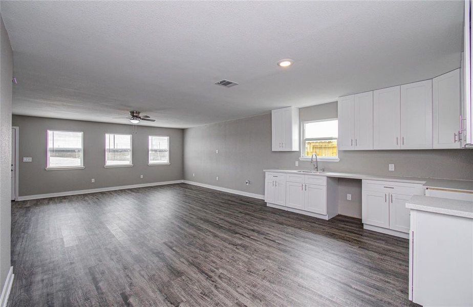 The open kitchen overlooks the spacious living area, creating an easy flow throughout the home.
