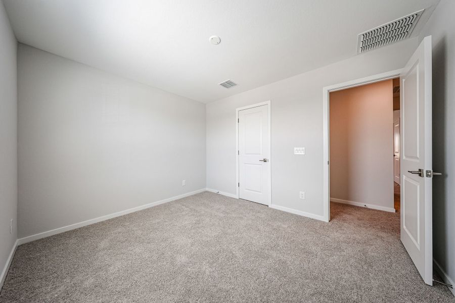 A hallway with white doors.