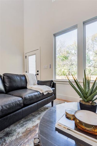 Living room with hardwood / wood-style floors and a healthy amount of sunlight