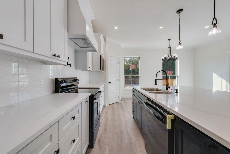 Kitchen with white cabinets, black dishwasher, hanging light fixtures, electric range, and custom range hood