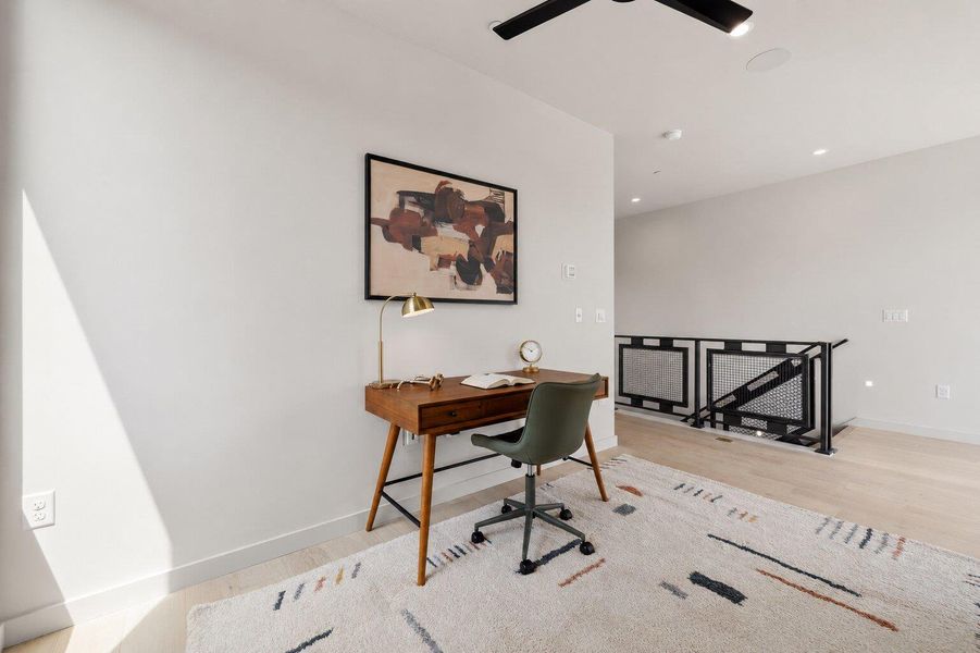 A well-lit, private study area with minimalist design and light-toned hardwood flooring. A well-lit, private study area with minimalist design and light-toned hardwood flooring.