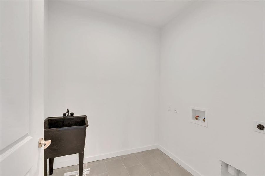 Washroom featuring light tile patterned flooring, washer hookup, and electric dryer hookup
