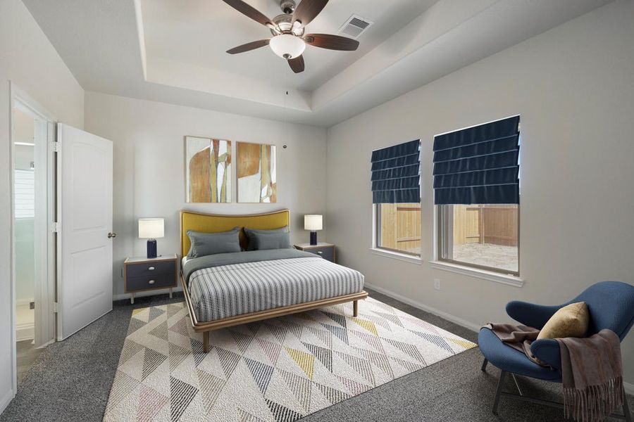 Bedroom with tray ceiling, ceiling fan, yellow upholstered bed, carpet, and navy roman shades on two windows Bedroom with tray ceiling, ceiling fan, yellow upholstered bed, carpet, and navy roman shades on two windows