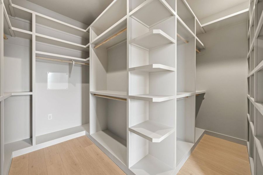 Ample shelving and hanging space defines this well-organized walk-in closet. Ample shelving and hanging space defines this well-organized walk-in closet.