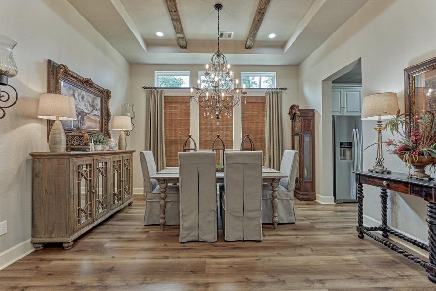 Offering warmth and elegance the formal dining with tray ceilings accented by wood beams, and a wall of windows allow in the natural light. Offering warmth and elegance the formal dining with tray ceilings accented by wood beams, and a wall of windows allow in the natural light.