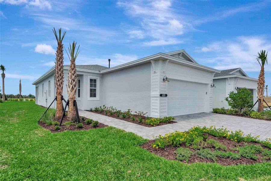 Front exterior of a new home in Cresswind at Lake Harris, Tavares, FL, highlighting curb appeal (Image 1).
